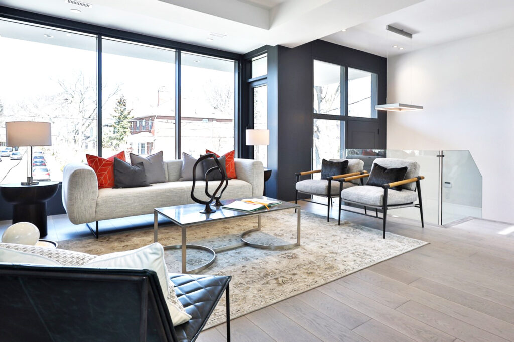 The home could have easily settled for the simple charm of all-white walls, but the decision to paint certain walls a rich dark blue truly revolutionized the space. This bold choice infused the room with vibrancy and perfectly highlighted the rental furniture, creating a striking contrast. Moreover, it brought a newfound balance to the concrete fireplace, which previously dominated the area, allowing it to integrate smoothly with the room's overall aesthetic. As a result, the space was transformed, gaining a lively and harmonious character that made every element feel thoughtfully placed and inviting.