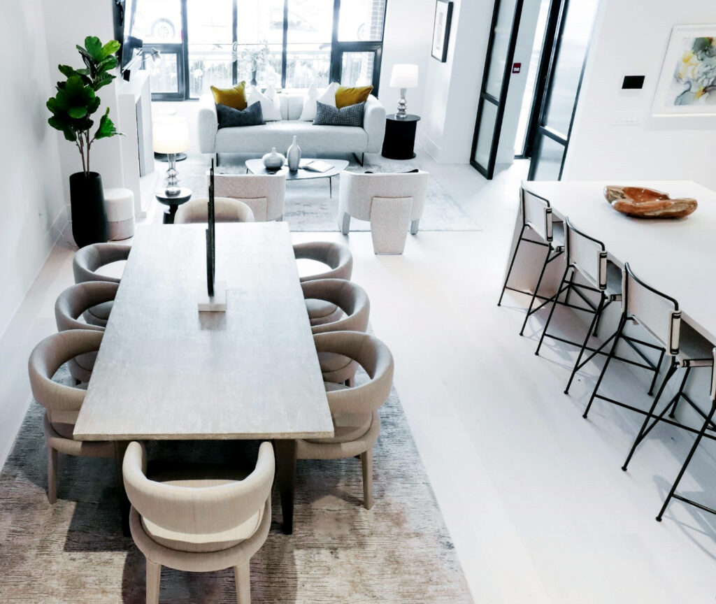 This petite condo saw significant improvement with the addition of properly-scaled rented furniture that respected the off-white color palette of the space. By maintaining ample walkway space, the layout maximizes the feeling of openness, cleverly conveying a sense of spaciousness within the confines of the small living area.